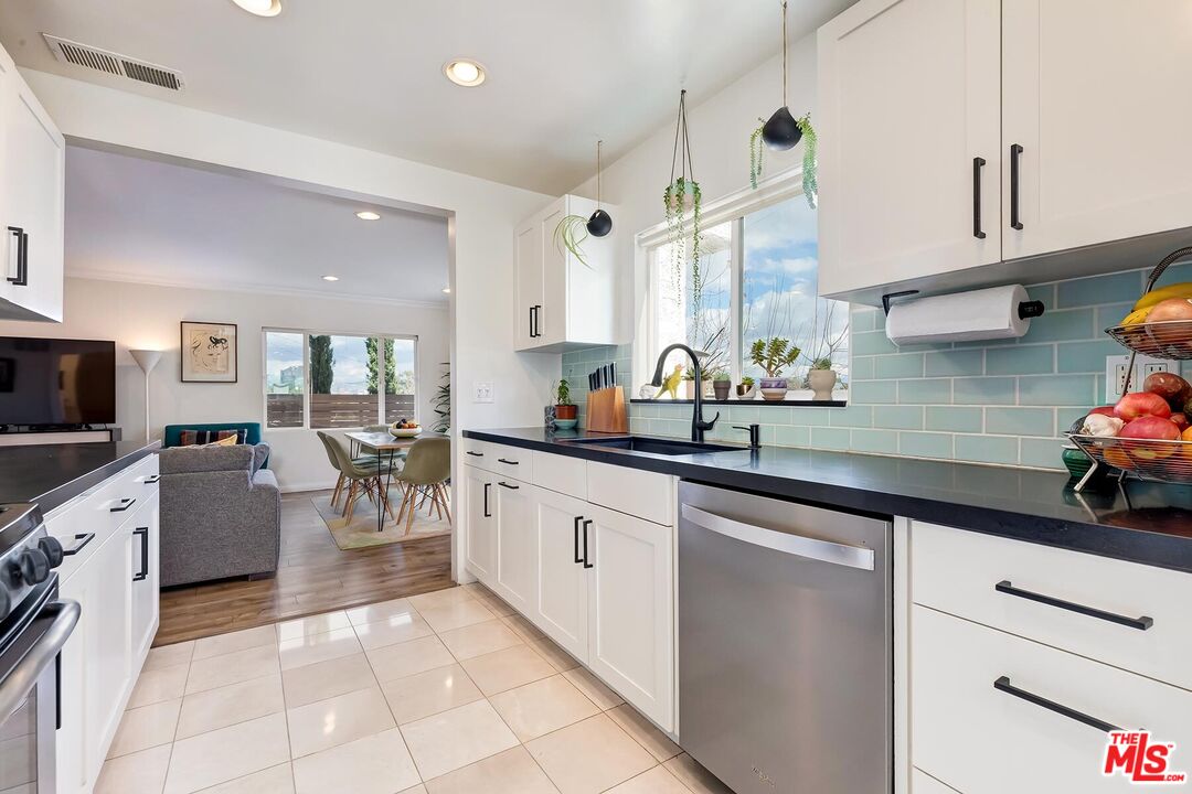 3838 Crestview Road Culver City, CA 90232 - Photo 20 of 53 a kitchen with a sink a counter space appliances and cabinets
