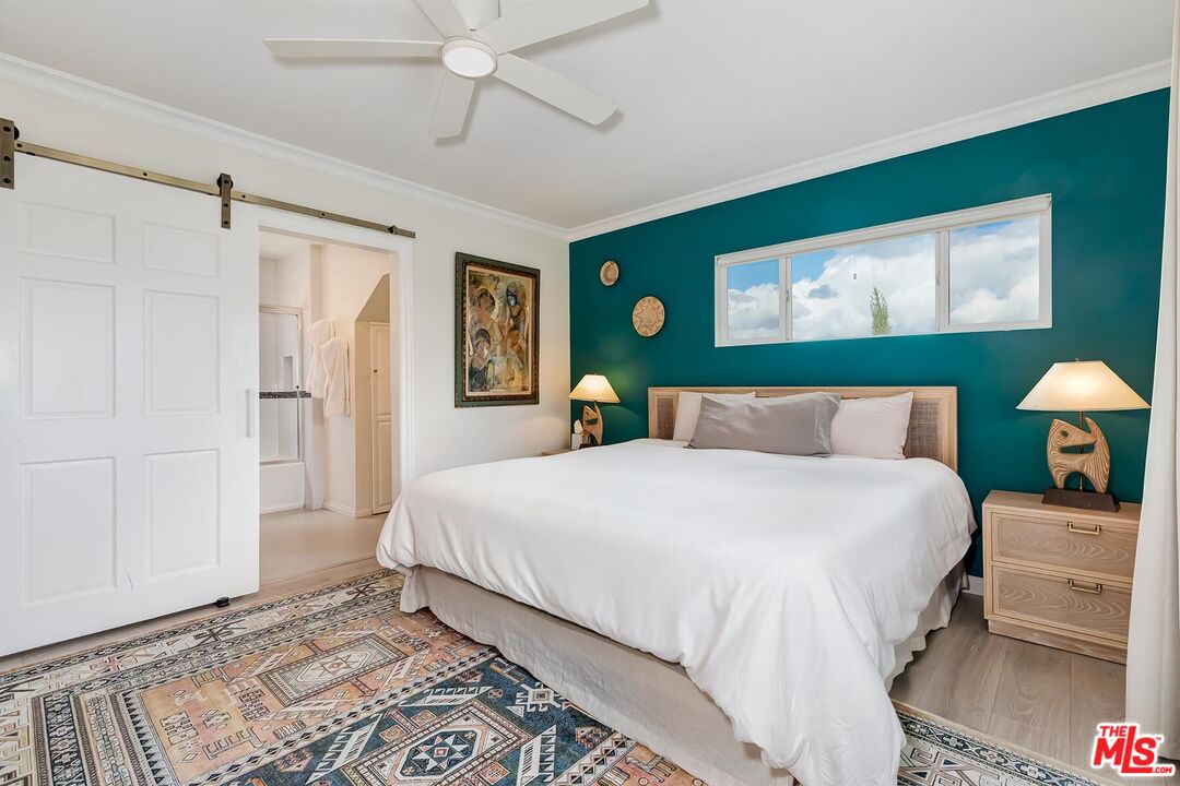 3838 Crestview Road Culver City, CA 90232 - Photo 29 of 53 a bedroom with a large bed and a chandelier