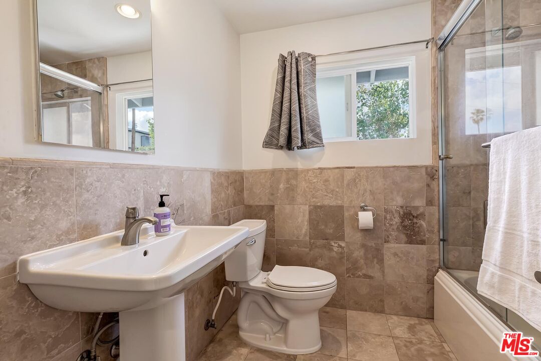 3838 Crestview Road Culver City, CA 90232 - Photo 34 of 53 a bathroom with a sink a toilet and a mirror