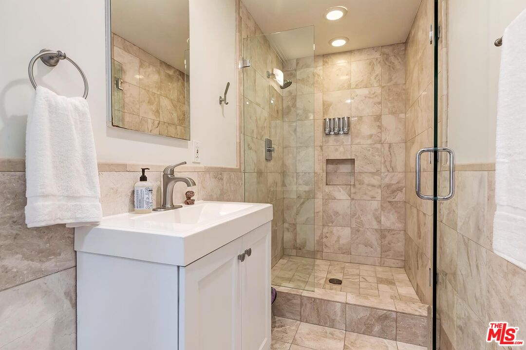 3838 Crestview Road Culver City, CA 90232 - Photo 37 of 53 a bathroom with a shower a sink and a mirror