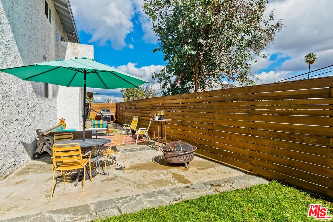 3838 Crestview Road Culver City, CA 90232 - Photo 42 of 53 a view of a patio with a table and chairs under an umbrella