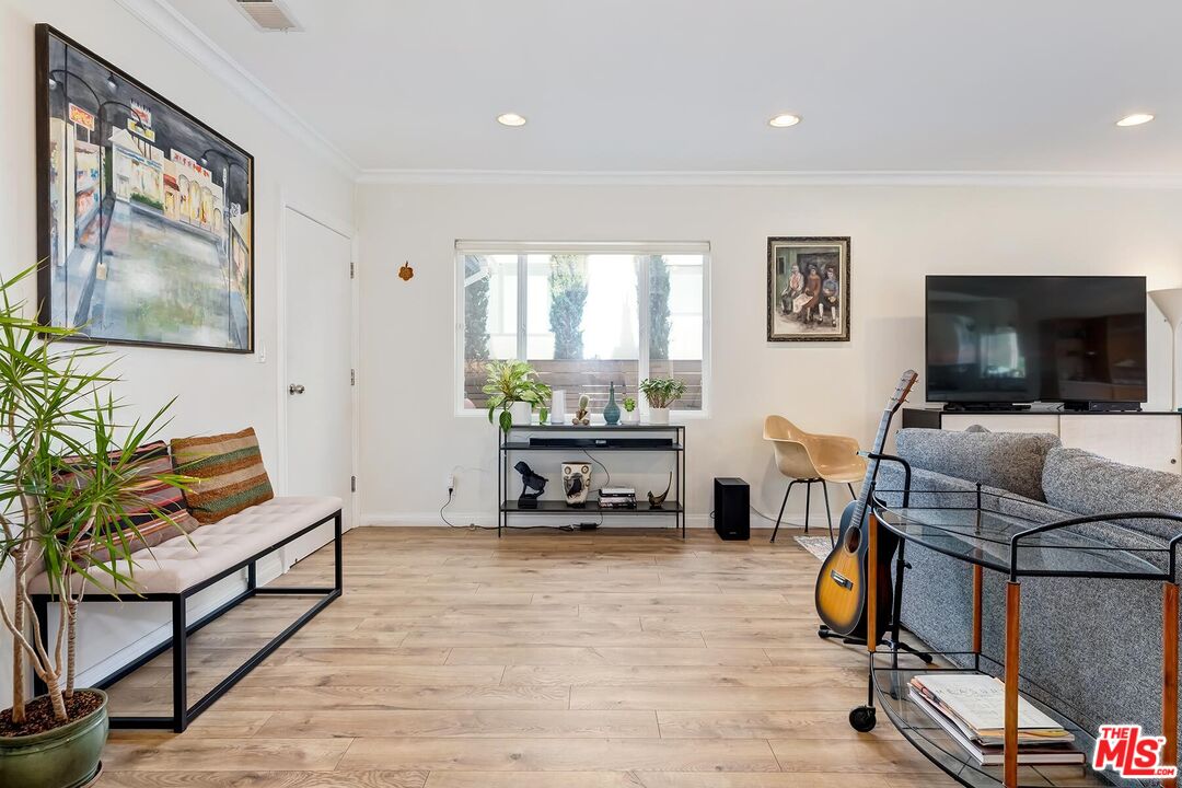 3838 Crestview Road Culver City, CA 90232 - Photo 8 of 53 a bedroom with furniture and a flat screen tv