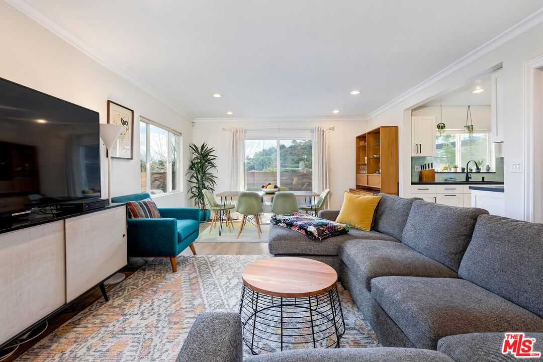 3838 Crestview Road Culver City, CA 90232 - Photo 10 of 53 a living room with furniture and a flat screen tv