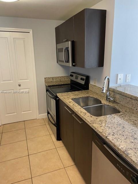 2650 Southwest 37th Avenue, Unit 501 Miami, FL 33134 - Photo 6 of 14 a kitchen with stainless steel appliances granite countertop a sink and a granite counter tops