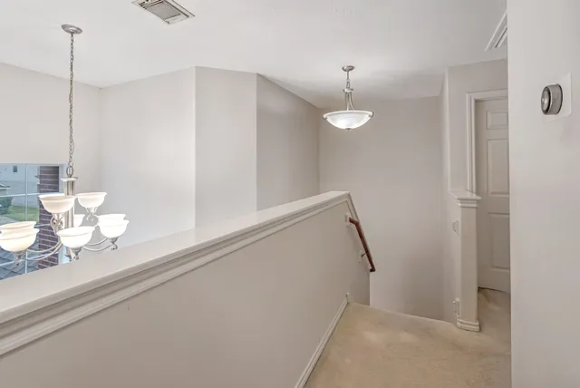 a view of a hallway with a chandelier