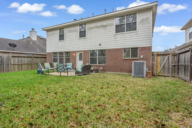 a backyard of a house with table and chairs