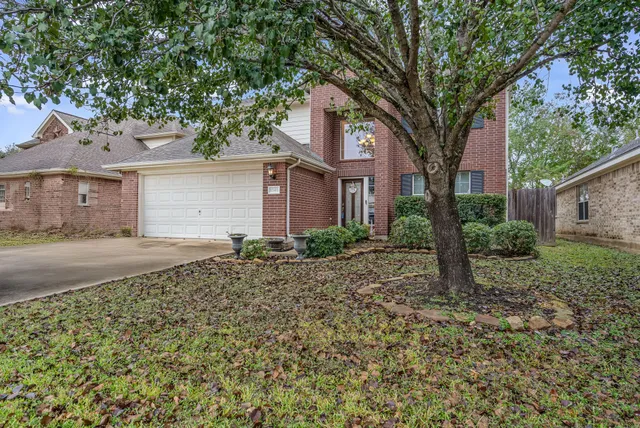 front view of a house with a trees