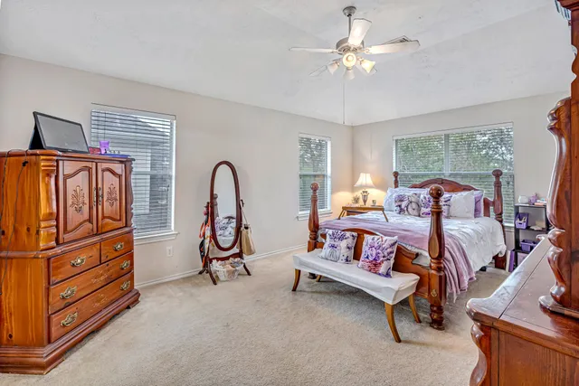 a bedroom with furniture and a chandelier