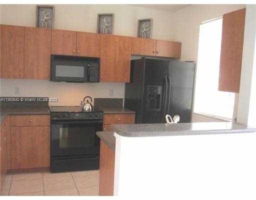 970 Abaco Lane Riviera Beach, FL 33404 - Photo 1 of 50 a kitchen with stainless steel appliances granite countertop a sink and a refrigerator