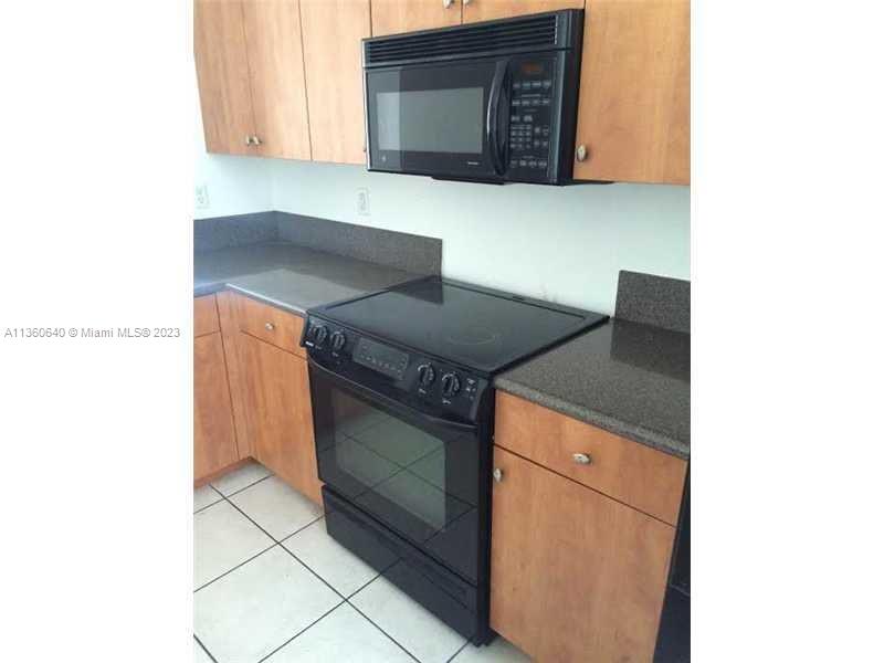 970 Abaco Lane Riviera Beach, FL 33404 - Photo 13 of 50 a kitchen with granite countertop cabinets and stove top oven