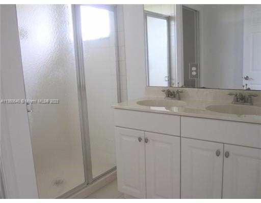 970 Abaco Lane Riviera Beach, FL 33404 - Photo 16 of 50 a bathroom with a sink and a mirror