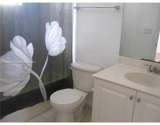 970 Abaco Lane Riviera Beach, FL 33404 - Photo 17 of 50 a white toilet sitting next to a bathroom sink