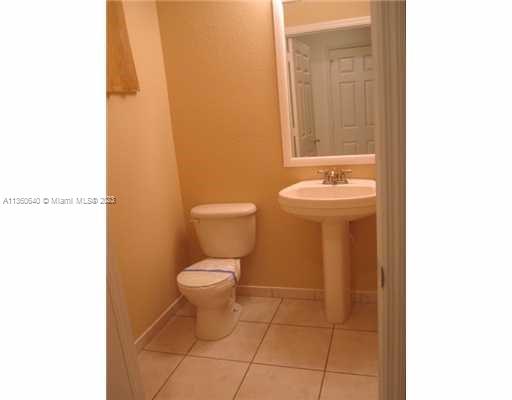 970 Abaco Lane Riviera Beach, FL 33404 - Photo 20 of 50 a bathroom with a toilet a sink and mirror