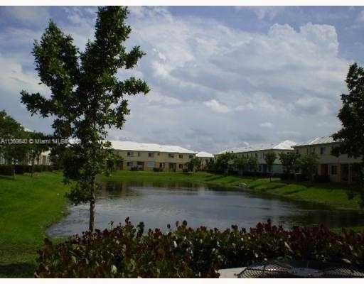 970 Abaco Lane Riviera Beach, FL 33404 - Photo 49 of 50 a view of a lake with a garden