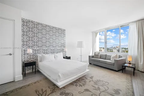 a bedroom with a bed and a table