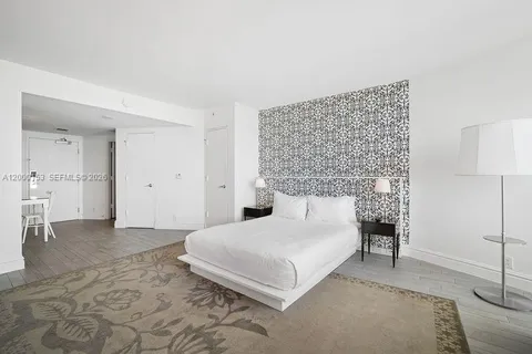 a bedroom with a bed and a couch