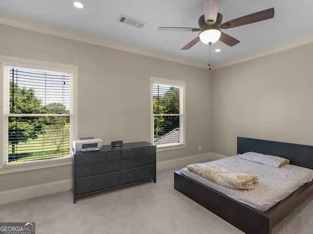 a dining room with furniture a chandelier and wooden floor