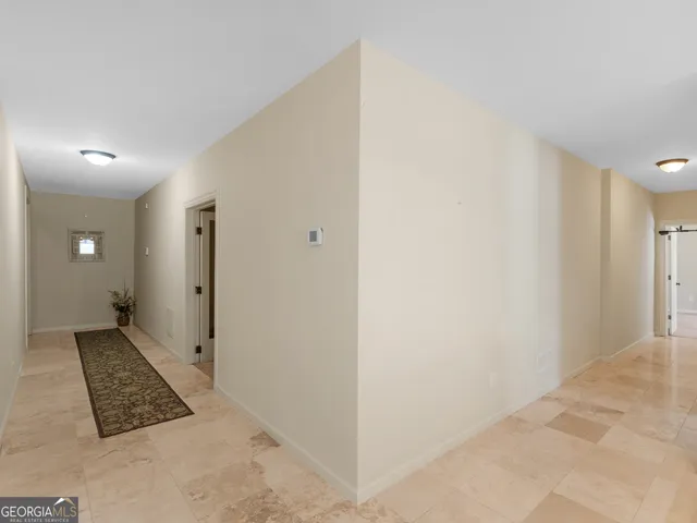 a living room with furniture and floor to ceiling windows