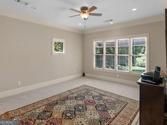 a dining hall with stainless steel appliances granite countertop a dining table chairs and a living room view