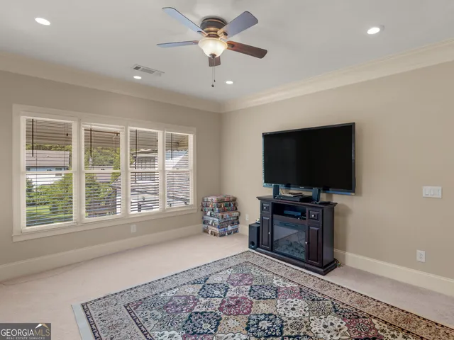 a dining room with furniture and a large window
