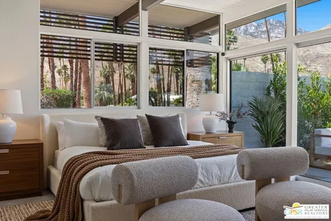 a view of a patio with couches table and chairs and potted plants