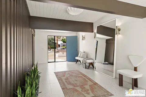 a kitchen with a table chairs sink and cabinets