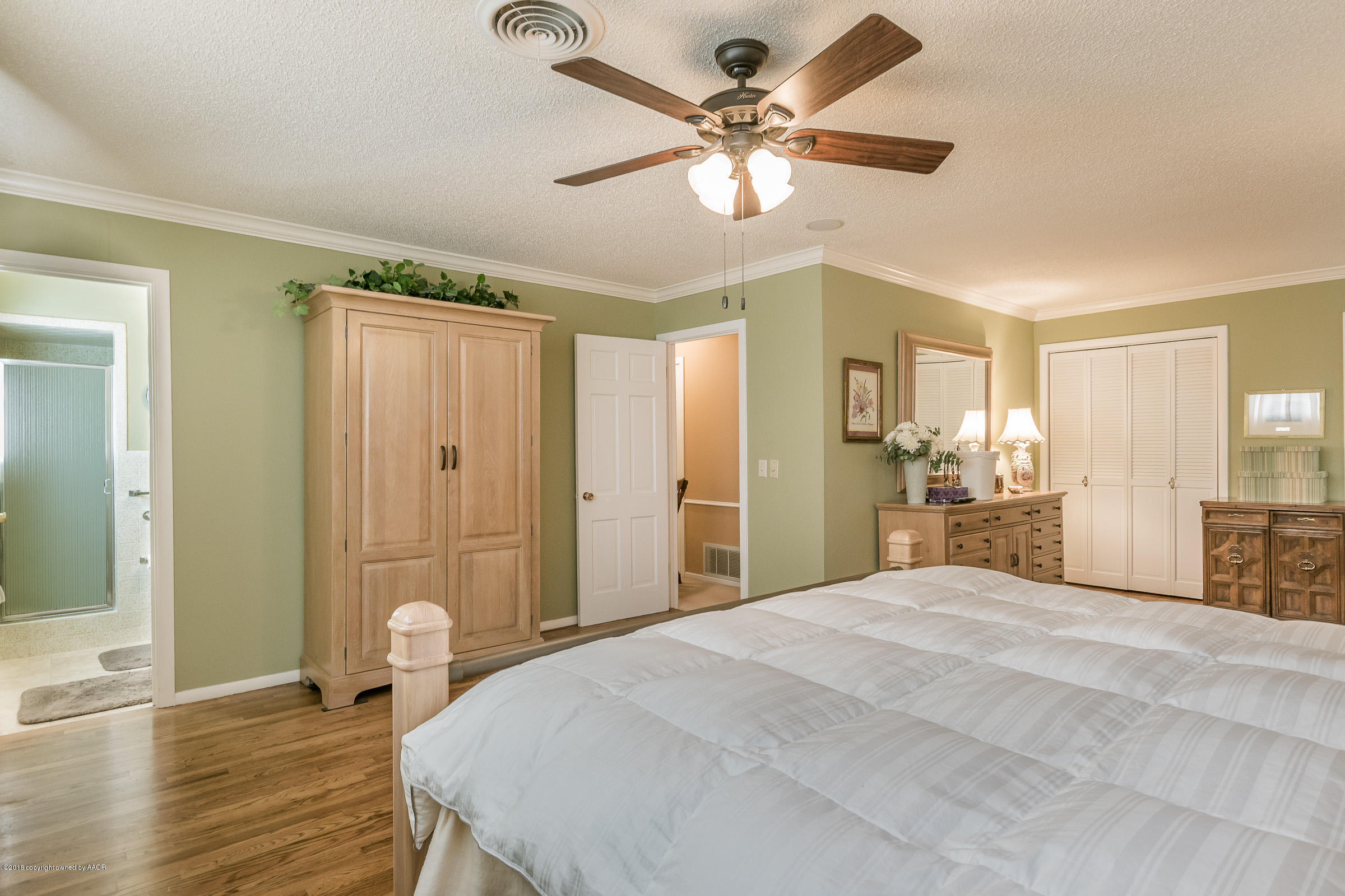 6709 Jameson Road Amarillo, TX 79106 - Photo 13 of 23 a spacious bedroom with a large bed a chandelier and closet