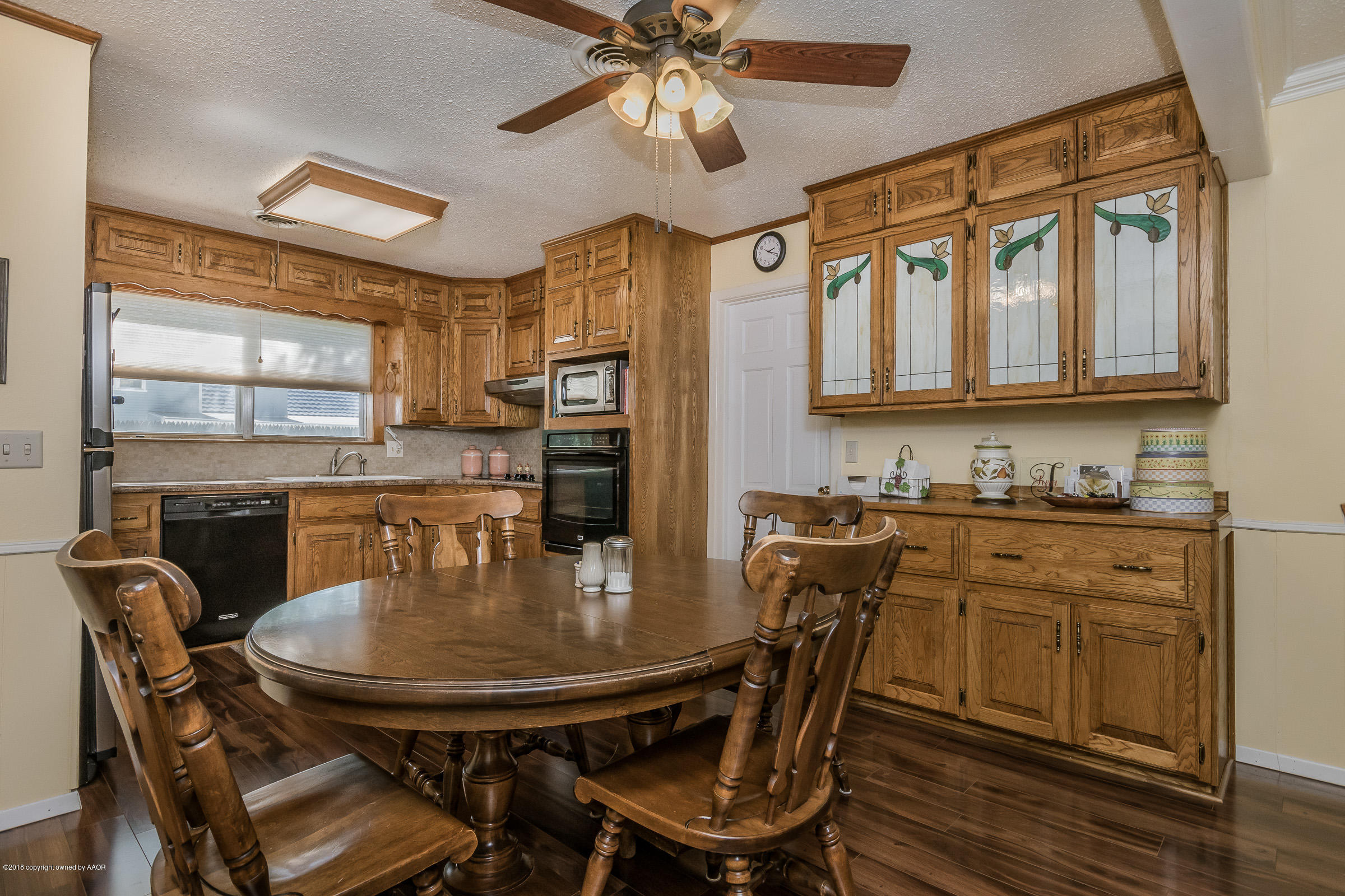 6709 Jameson Road Amarillo, TX 79106 - Photo 7 of 23 a kitchen with stainless steel appliances granite countertop a dining table chairs and granite counter tops