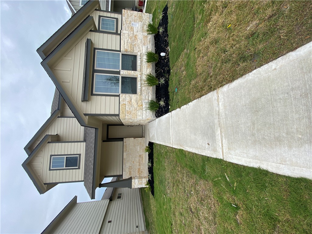 a front view of a house with a yard