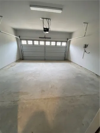 en empty room with windows and fan