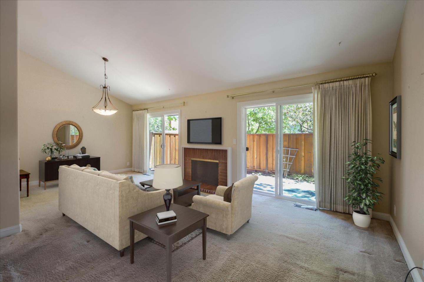 10854 Northview Square Cupertino, CA 95014 - Photo 2 of 18 a living room with furniture a fireplace and a flat screen tv