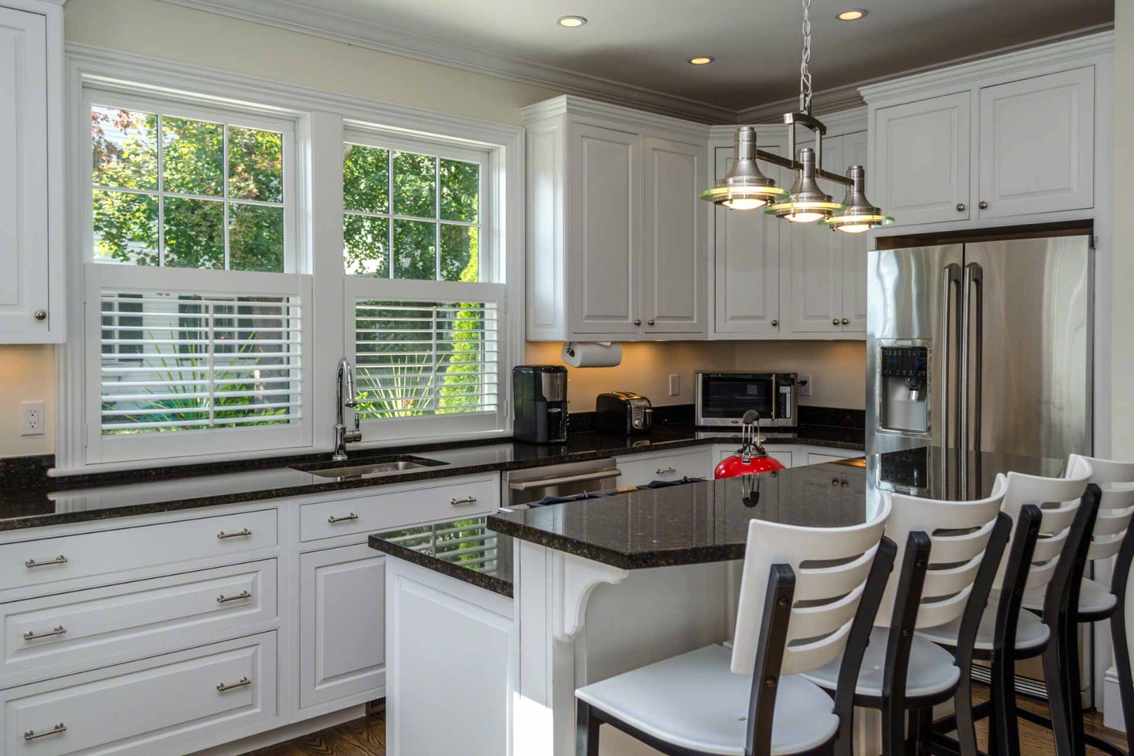 37 Simpsons Lane Edgartown, MA 02539 - Photo 9 of 28 a kitchen with kitchen island granite countertop a sink cabinets and window