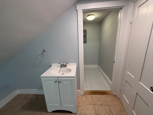 a bathroom with a sink and mirror