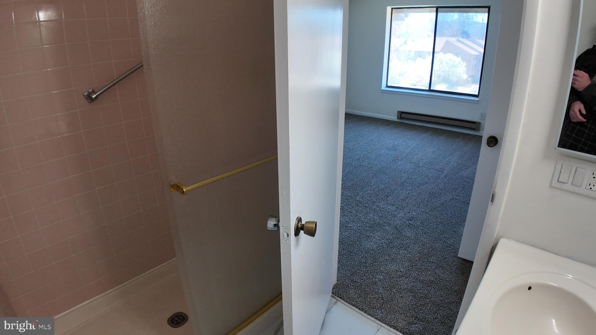 15311 Beaverbrook Court, Unit 903B Silver Spring, MD 20906 - Photo 31 of 36 a bathroom with a window and a shower