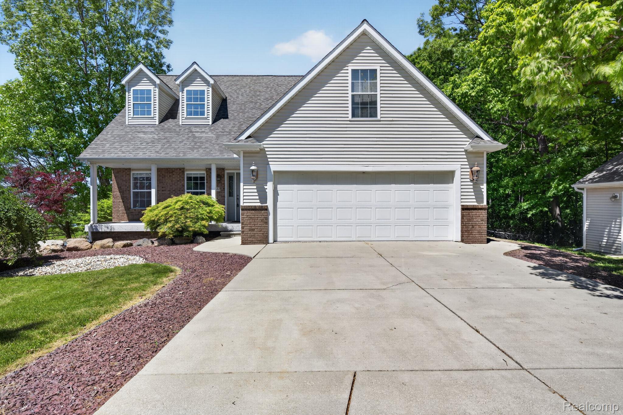 9055 Hegel Road Grand Blanc, MI 48439 - Photo 17 of 62 Traditional-style residence featuring light-colored siding and a covered front porch with brick accents
