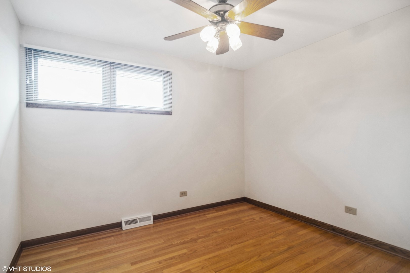 174 Lance Drive Des Plaines, IL 60016 - Photo 13 of 25 an empty room with wooden floor fan and windows