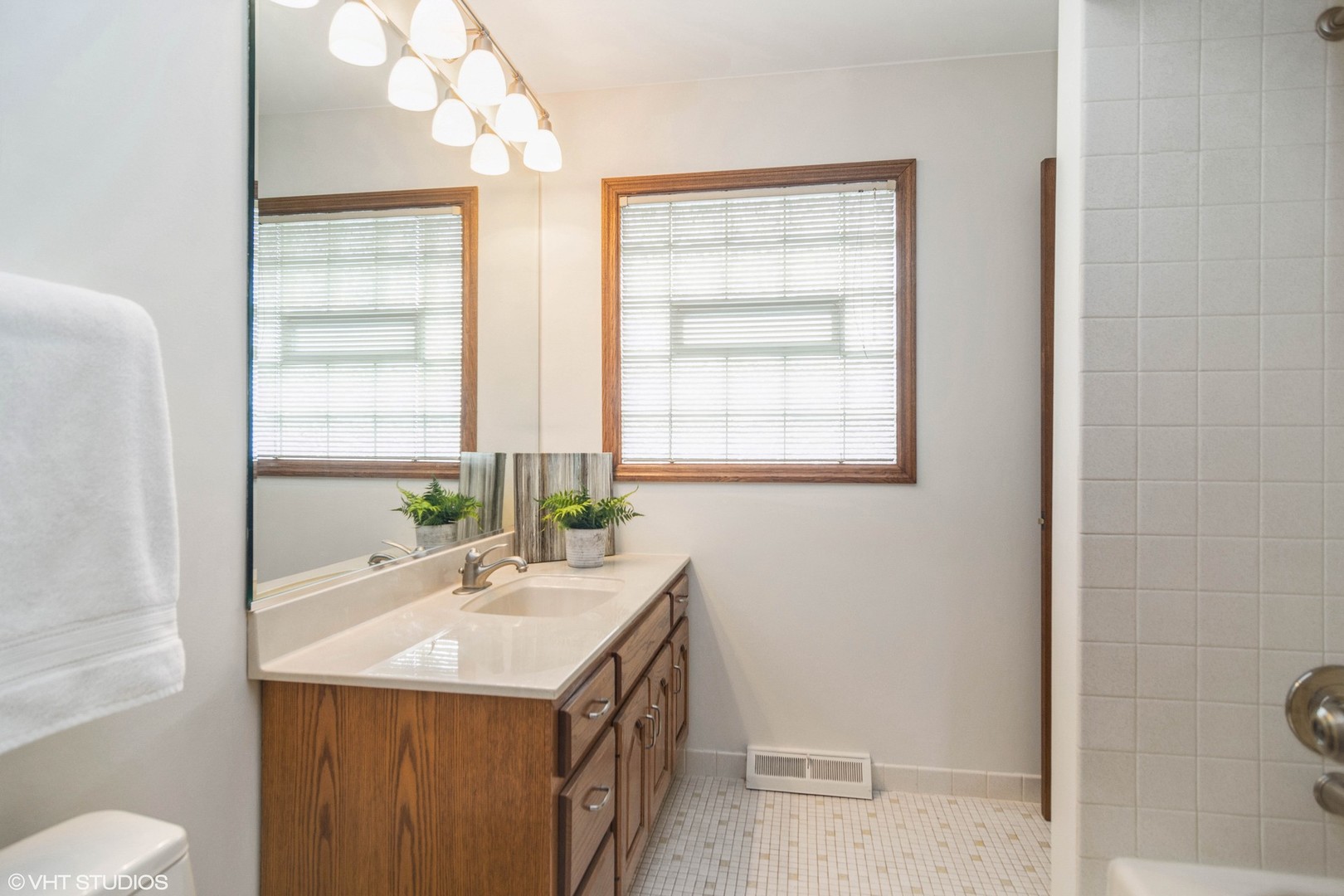 174 Lance Drive Des Plaines, IL 60016 - Photo 14 of 25 a bathroom with a sink vanity granite toilet and a mirror