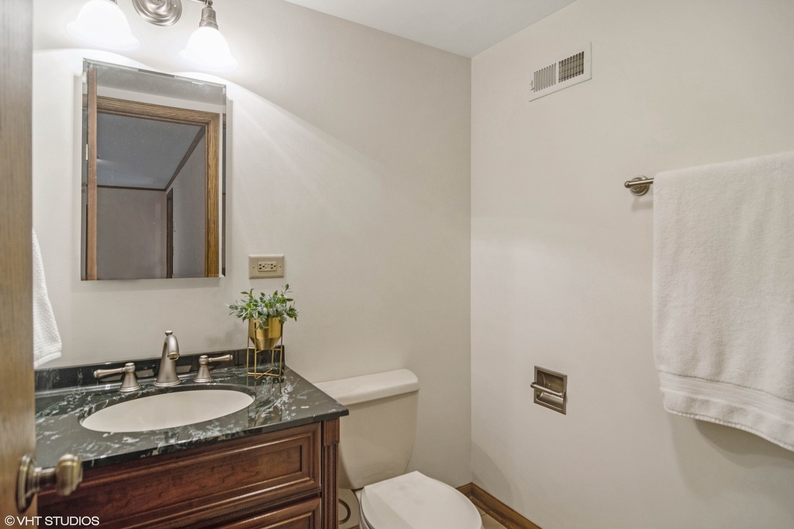 174 Lance Drive Des Plaines, IL 60016 - Photo 15 of 25 a bathroom with a granite countertop toilet sink and mirror