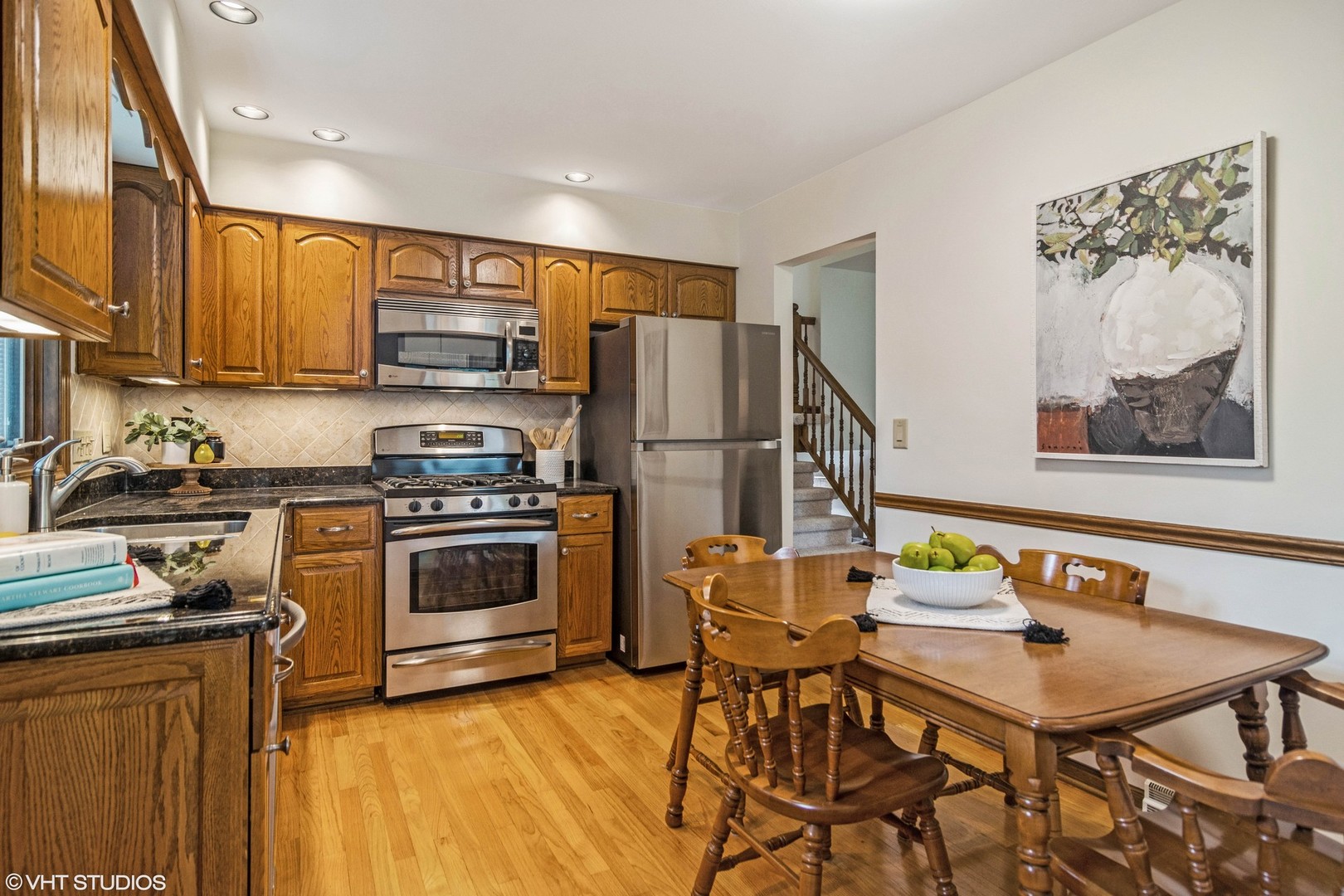 174 Lance Drive Des Plaines, IL 60016 - Photo 6 of 25 a kitchen with stainless steel appliances a stove a refrigerator and a dining table