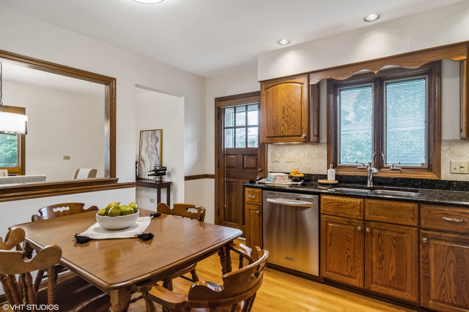 174 Lance Drive Des Plaines, IL 60016 - Photo 7 of 25 a kitchen with stainless steel appliances granite countertop a stove a sink a dining table and chairs