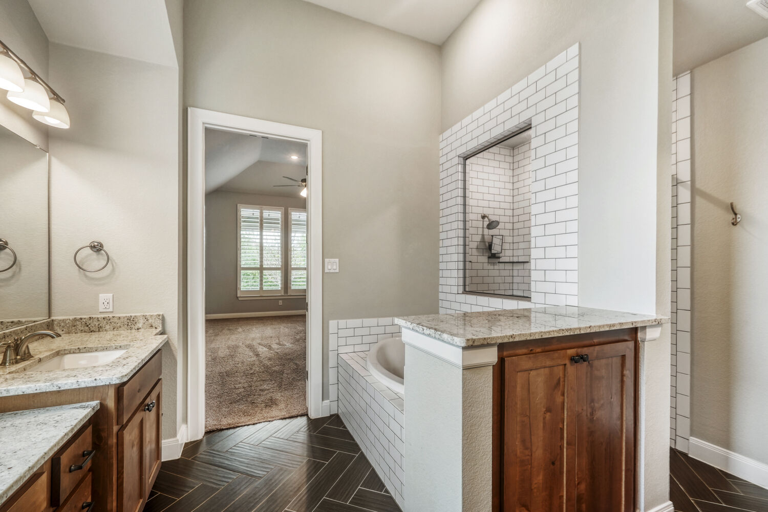 1401 Calago Cove Leander, TX 78641 - Photo 17 of 40 a bathroom with a granite countertop sink and a mirror