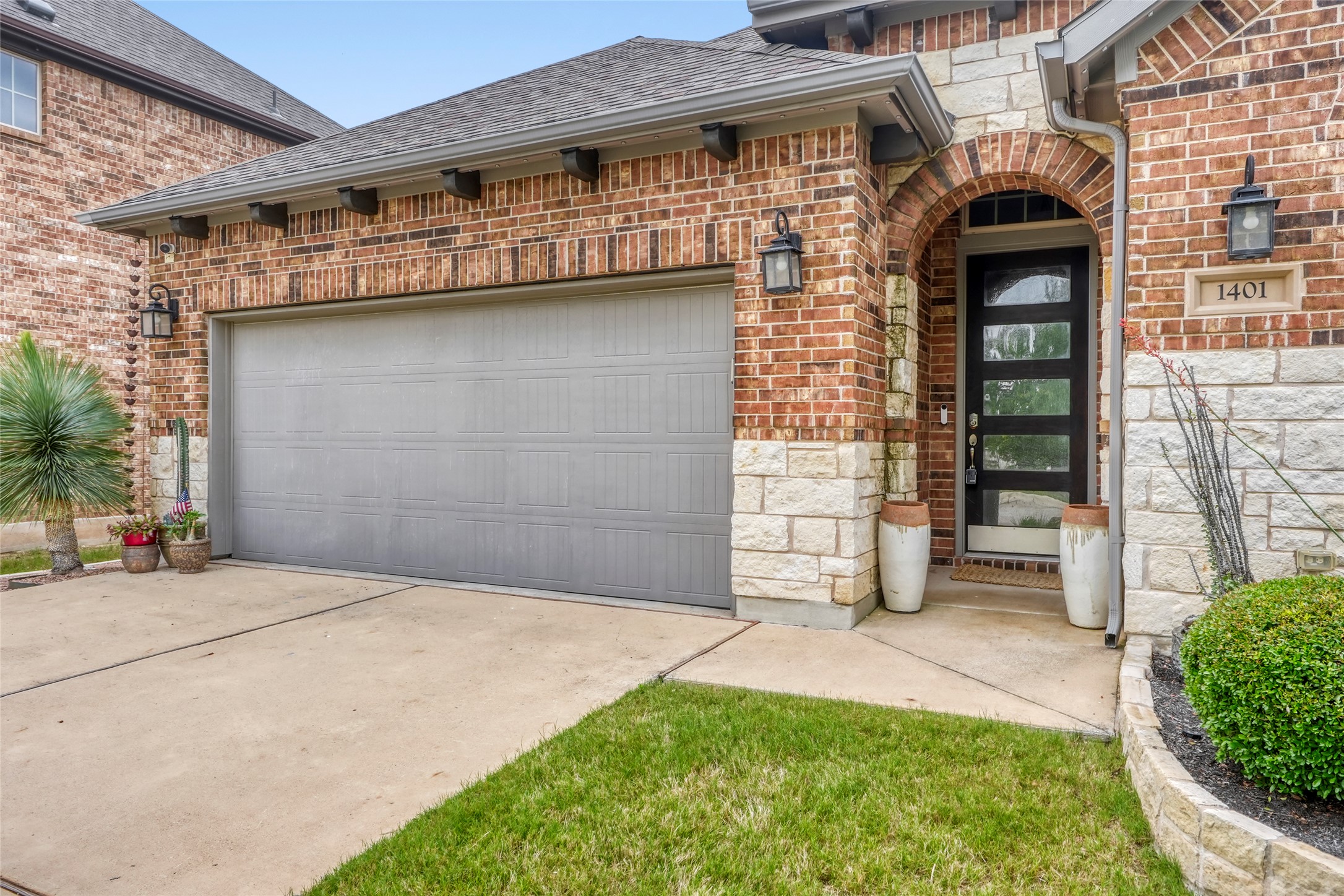 1401 Calago Cove Leander, TX 78641 - Photo 2 of 40 Brick and stone exterior featuring an arched entryway