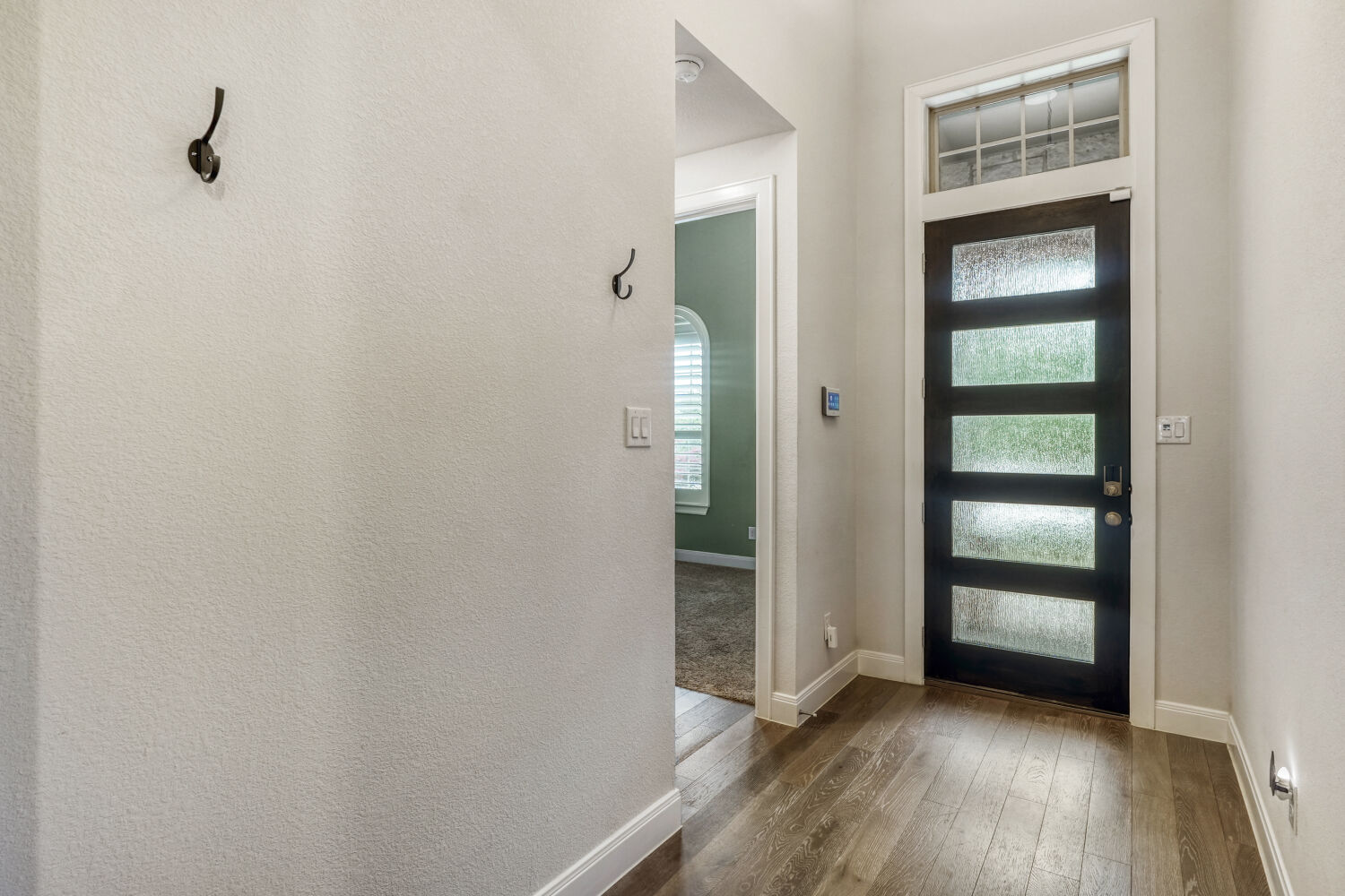 1401 Calago Cove Leander, TX 78641 - Photo 4 of 40 a view of an empty room with wooden floor and a window