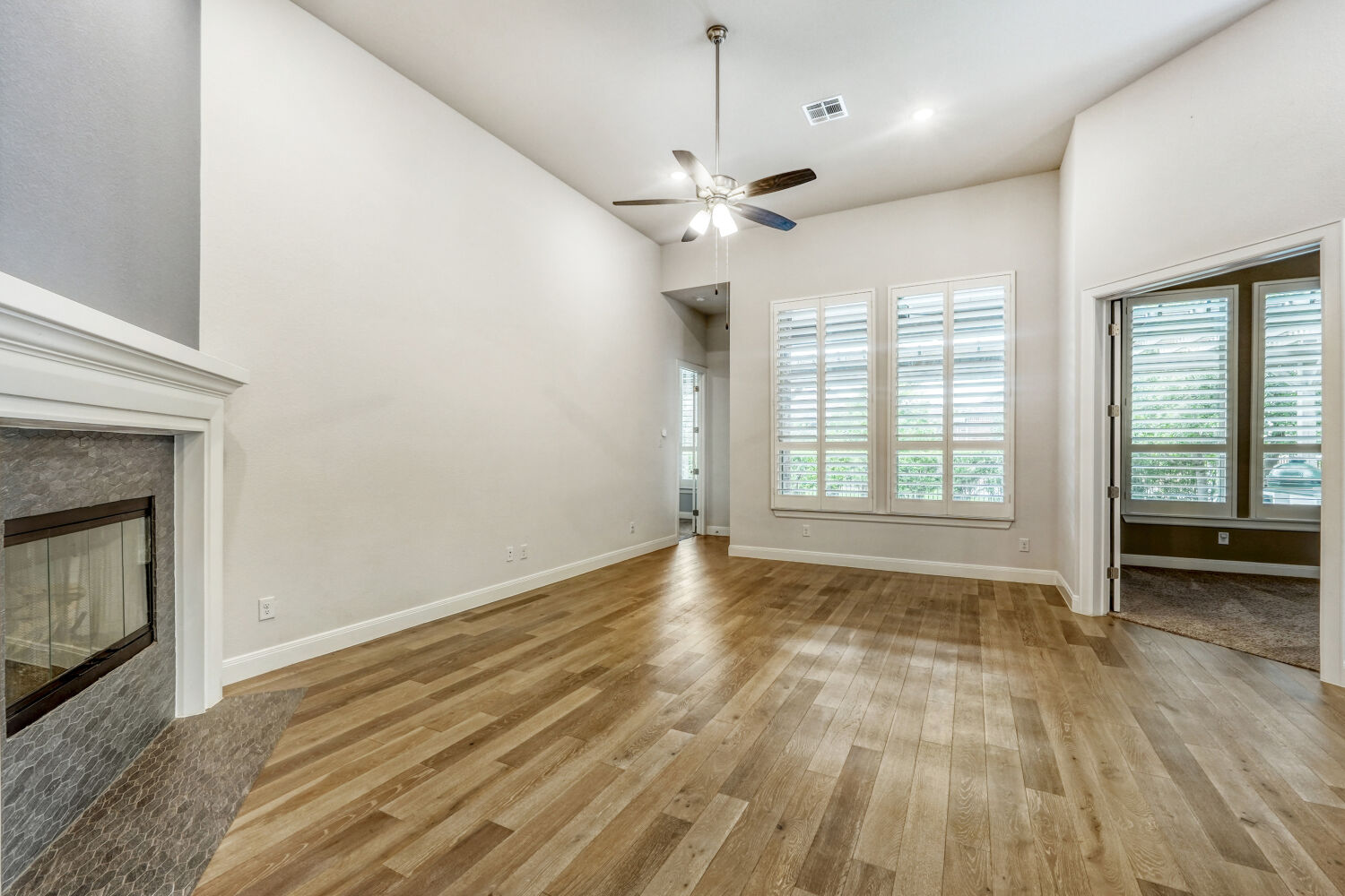 1401 Calago Cove Leander, TX 78641 - Photo 5 of 40 a view of an empty room with a fireplace and a window