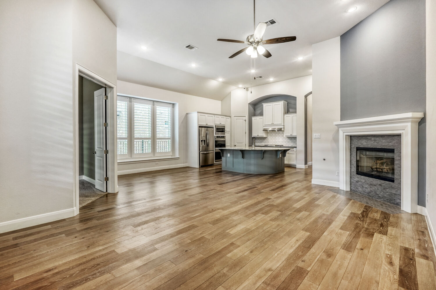 1401 Calago Cove Leander, TX 78641 - Photo 7 of 40 an empty room with kitchen and fireplace