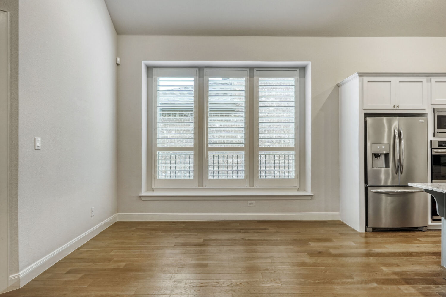 1401 Calago Cove Leander, TX 78641 - Photo 8 of 40 a view of empty room with wooden floor and a window