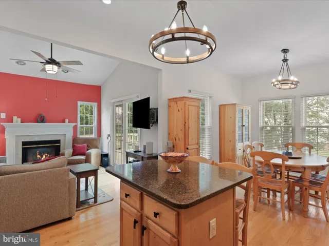 a living room with furniture a chandelier and a fireplace