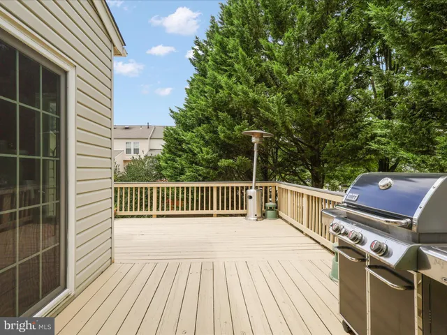 a view of balcony with wooden floor and fence