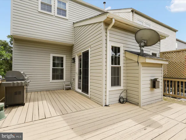 a front view of house with barbeque oven and seating space