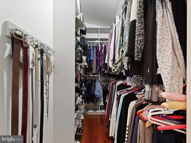 a view of walk in closet with clothes